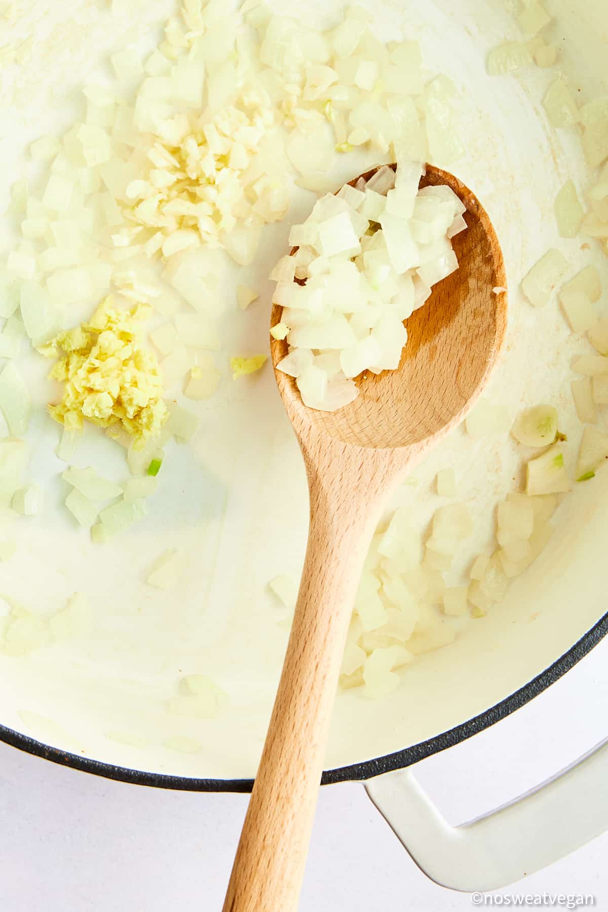 Adding ginger and garlic to curry.