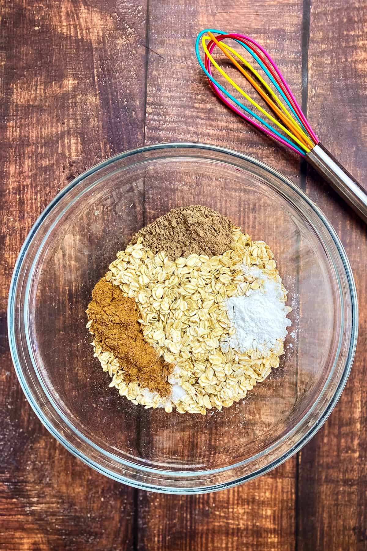 Oats and dry ingredients for baked oats in a bowl.