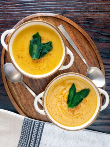 Roasted acorn squash soup in two bowls.