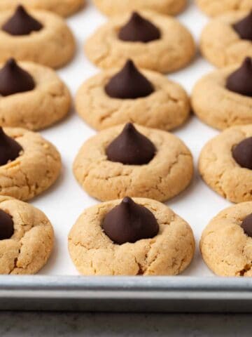 Vegan peanut butter blossoms on a baking sheet.